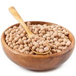 Chick-pea in wooden bowl on wooden background close up
